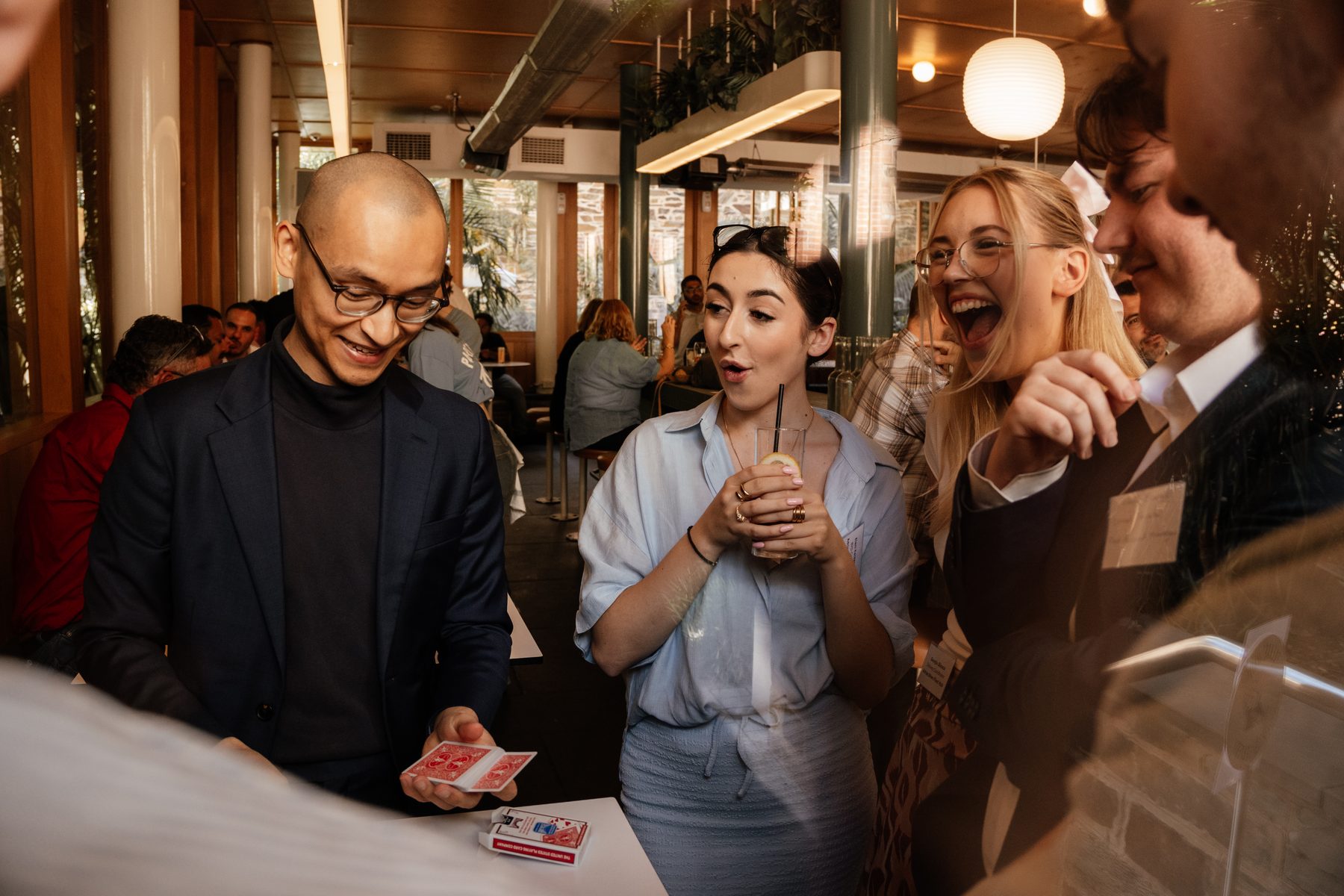 Guests reacting to close-up magic at a corporate party