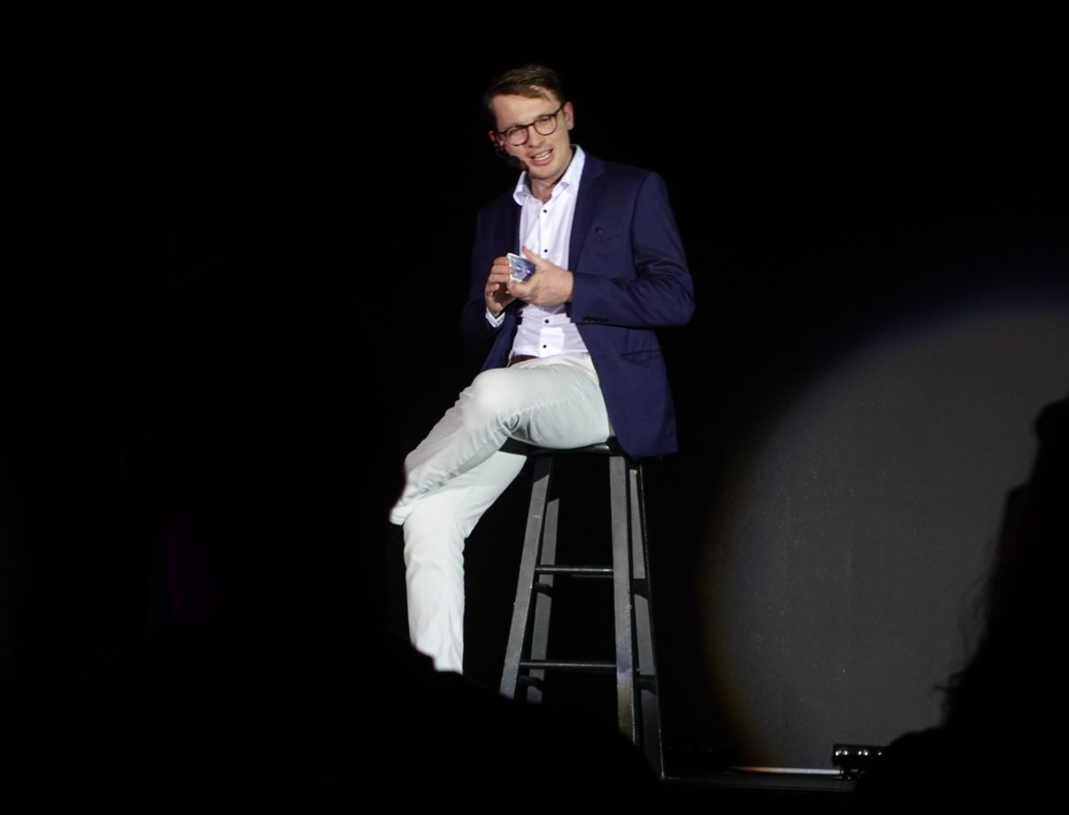 Sam headlining on a spotlit stage